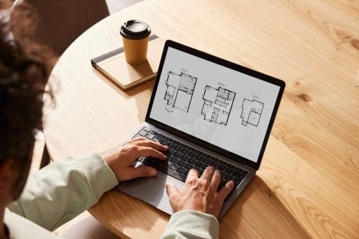 Reviewing floor plans on a laptop